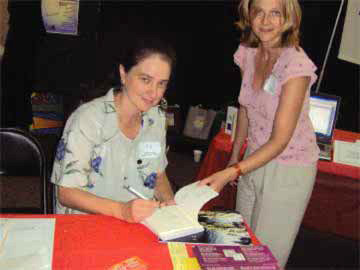Angela Signs Her Book L